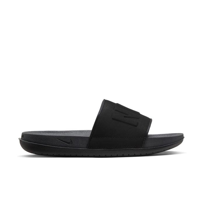 Women's black slide sandal side view with textured footbed and NIKE swoosh