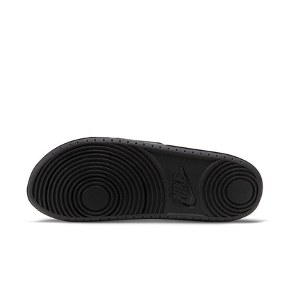 Women's black slide sandal outsole with concentric tread and NIKE mark