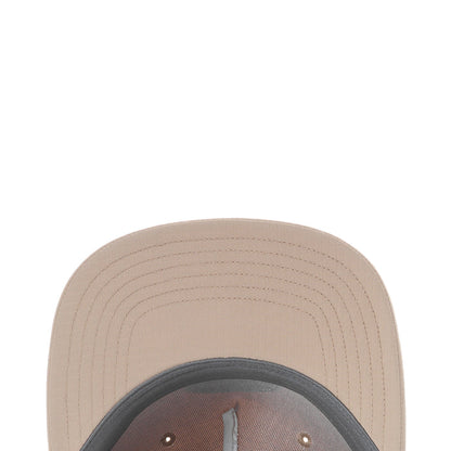 Light beige cap crown close-up with ventilated stitching on the brim.