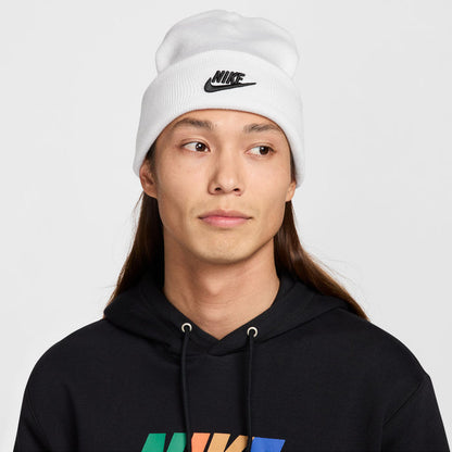 White knit beanie with black Nike swoosh logo on front