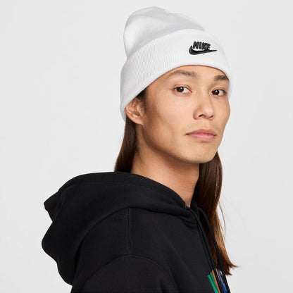 White knit beanie with black Nike swoosh logo on side