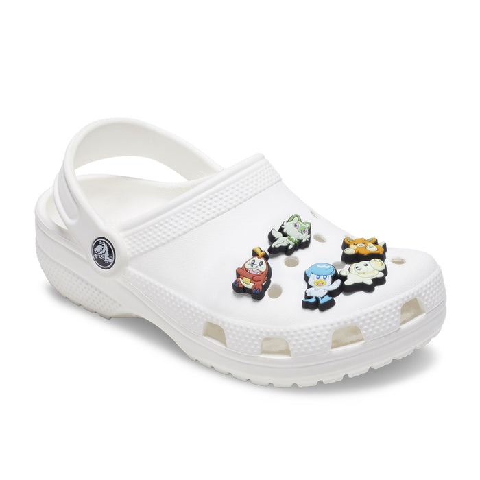 Pokemon Jibbitz charms on white clogs, five colorful character pieces