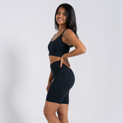 Women’s black high-waist bike shorts, back view on model with smooth contour seams