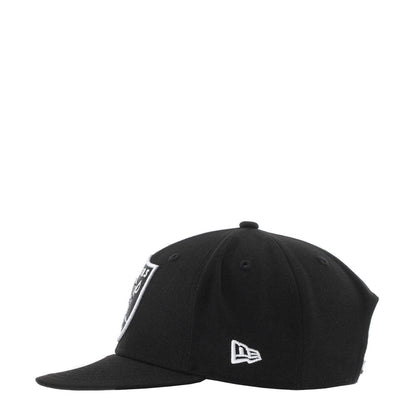 Black snapback cap with small white Raiders logo patch on the front