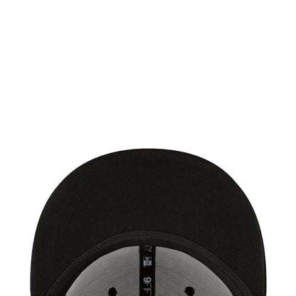 Black cap brim interior close-up with New Era label on the underside