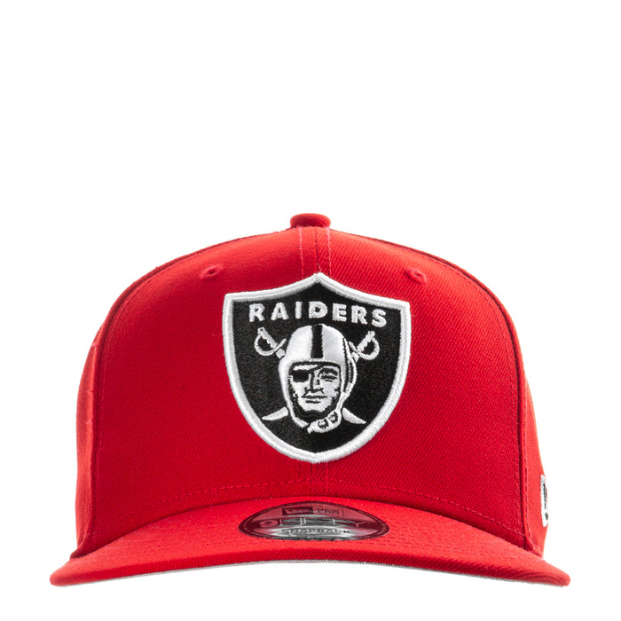 Red baseball cap with Raiders shield logo patch at center