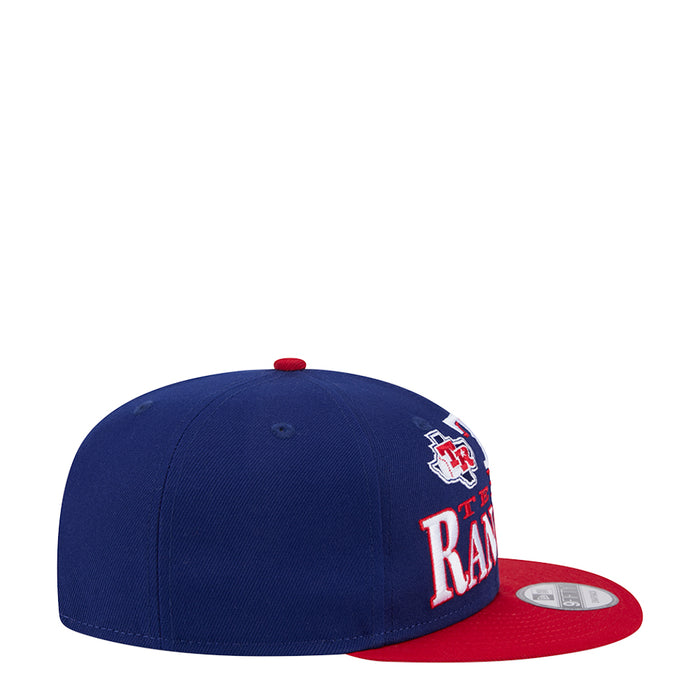 Two-tone baseball cap with navy crown, red brim, and side team logo embroidery.
