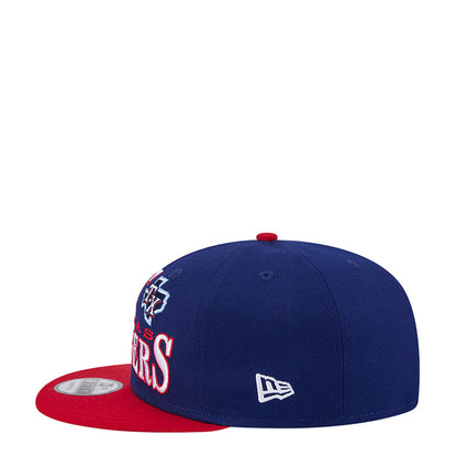 Two-tone baseball cap with navy crown, red brim, and small New Era logo on side.