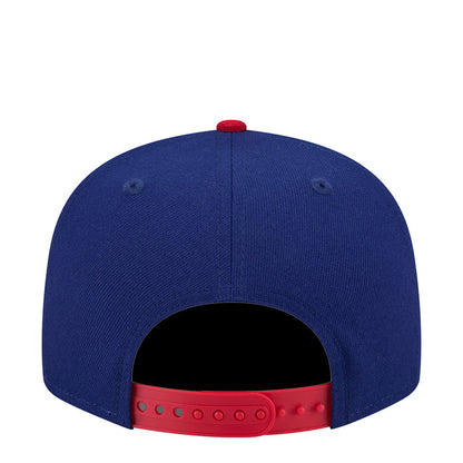 Two-tone baseball cap with navy crown and red adjustable snapback strap.