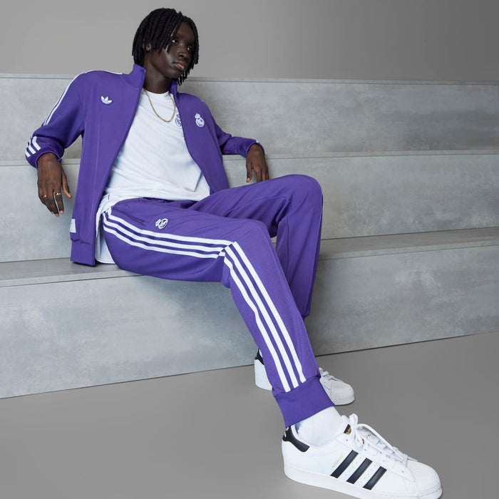 Purple track pants with white triple side stripes and club crest on thigh