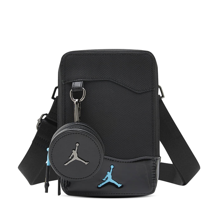Black crossbody bag with zip top, front flap, and blue Jumpman logo patch