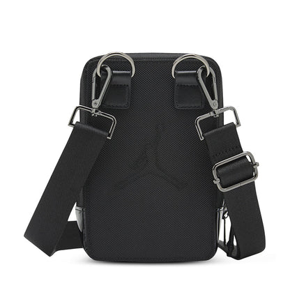Black crossbody bag with dual D-ring straps and adjustable buckles