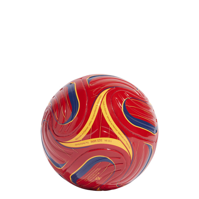 Red mini soccer ball with yellow curves and blue accents, visible seam lines