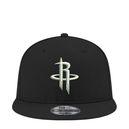 Black snapback cap with NBA Rockets logo on front panel, curved brim