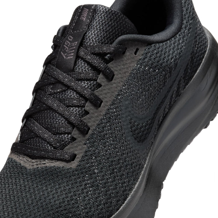 Close-up of black lace-up knit upper with embossed logo near the tongue