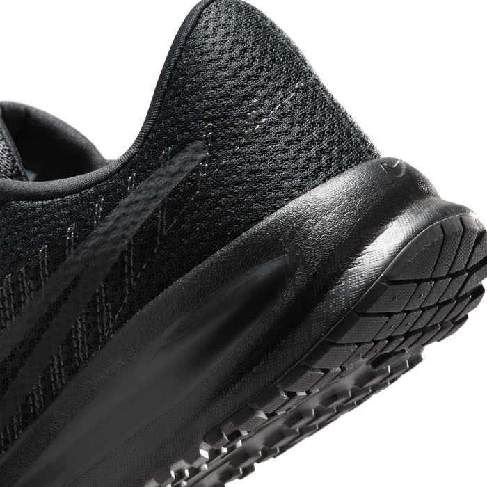 Side close-up of black running shoe with textured knit and durable rubber sole
