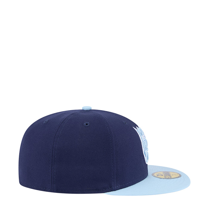 Two-tone baseball cap with dark navy crown and light brim, side view