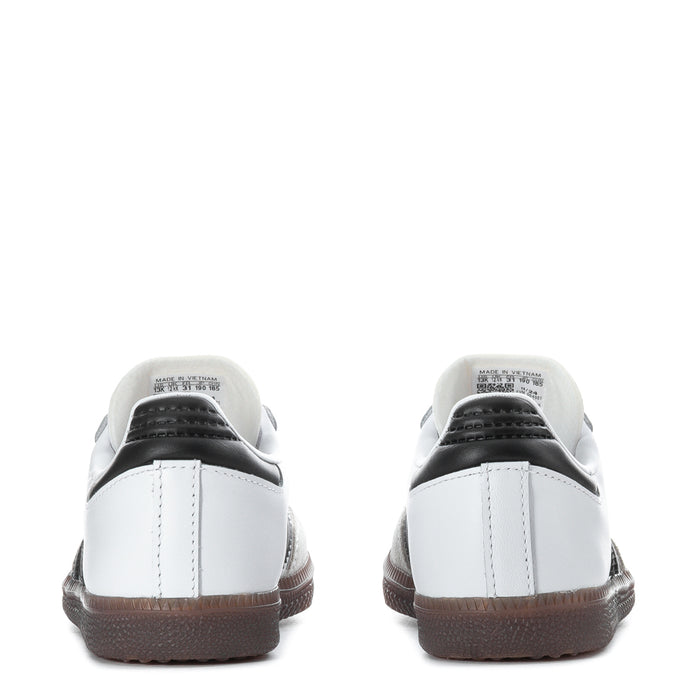 Kids white sneakers from the back with black heel panel and brown rubber sole