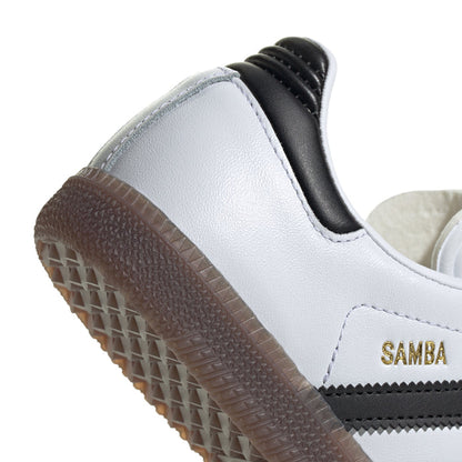 Kids white sneaker side close-up with black heel detail, gum-brown tread, SAMBA logo