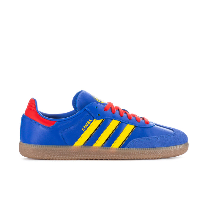 Men's blue low-top sneakers with yellow triple stripes, red laces, gum sole