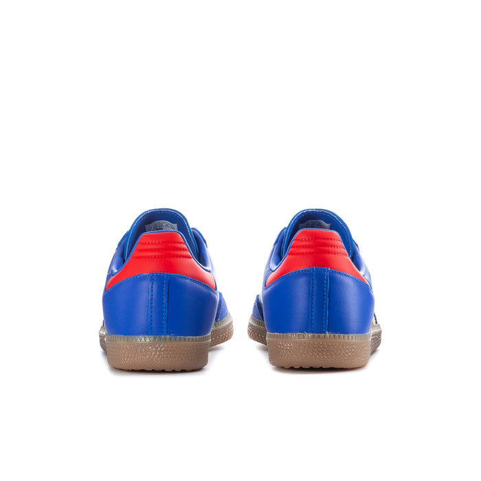 Men's blue sneakers with red heel trim, yellow stripe detail and gum outsole