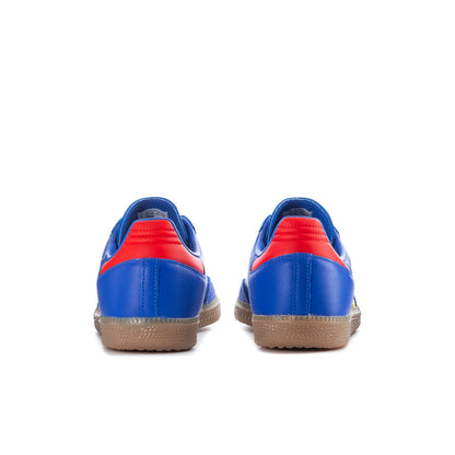 Men's blue sneakers with red heel trim, yellow stripe detail and gum outsole