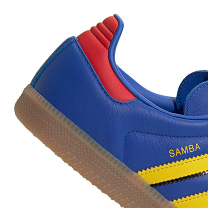 Men's blue sneaker side panel with red heel trim, yellow stripe and Samba branding