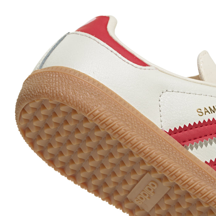 Kids sneaker side sole detail, gum rubber tread with red-and-cream upper