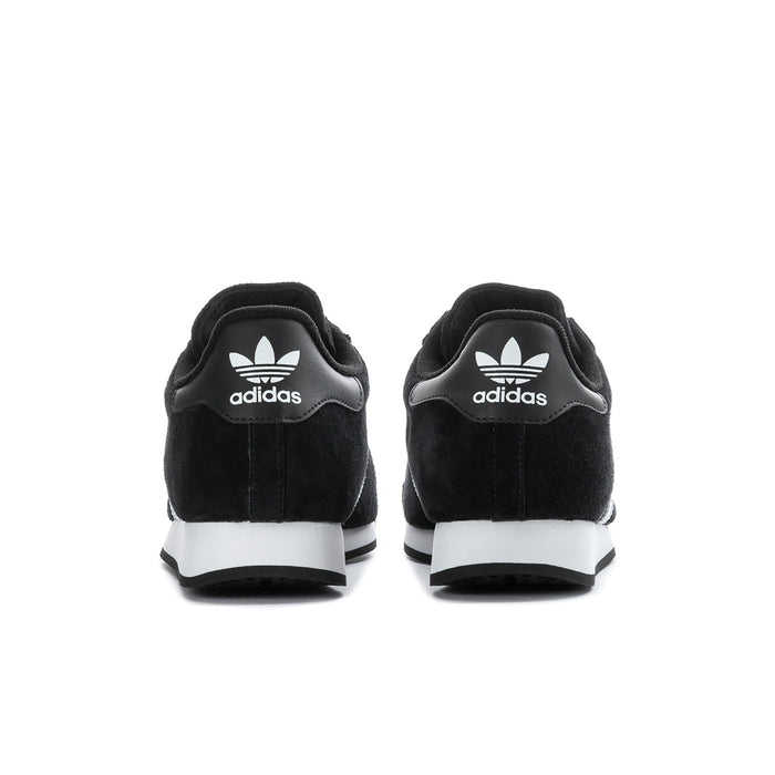 Black suede sneakers with adidas logo on heels and white midsole