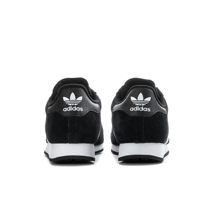Black suede sneakers with adidas logo on heels and white midsole