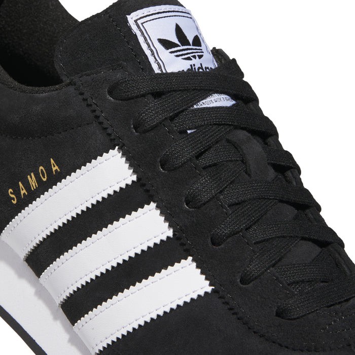 Black suede upper close-up with white three stripes and SAMOA lettering on side