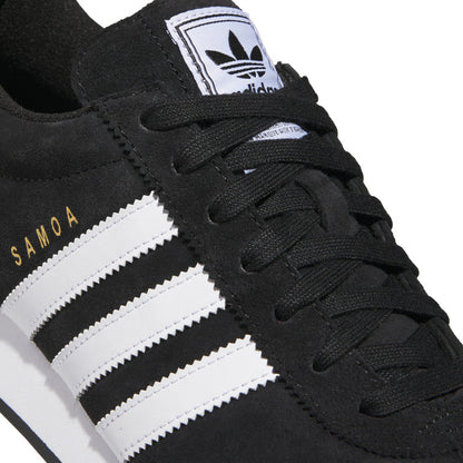 Black suede upper close-up with white three stripes and SAMOA lettering on side
