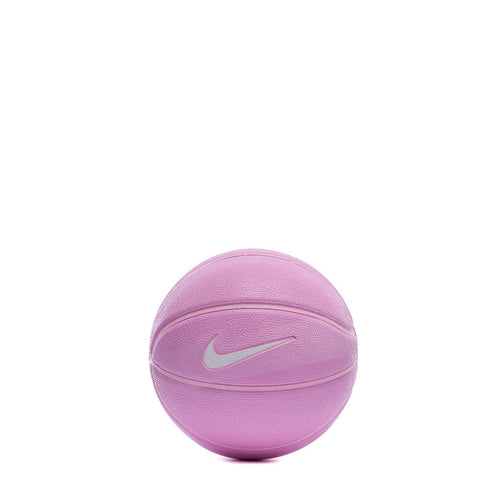 Pink mini basketball with Nike swoosh logo on textured surface