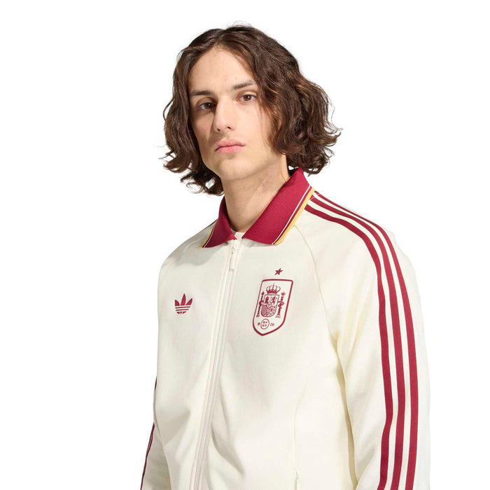 Men's off-white zip-up jacket close-up with burgundy-striped sleeves and crest chest patch