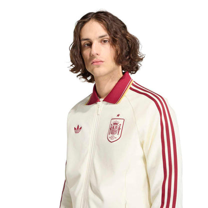 Men's off-white zip-up jacket close-up with burgundy-striped sleeves and crest chest patch