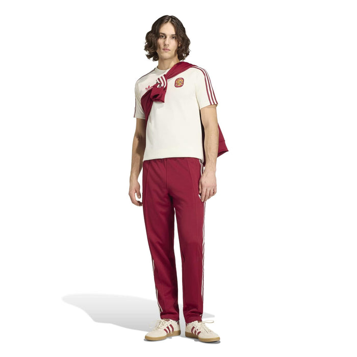 Men's off-white T-shirt with maroon sleeve stripes and Spain crest, side view.