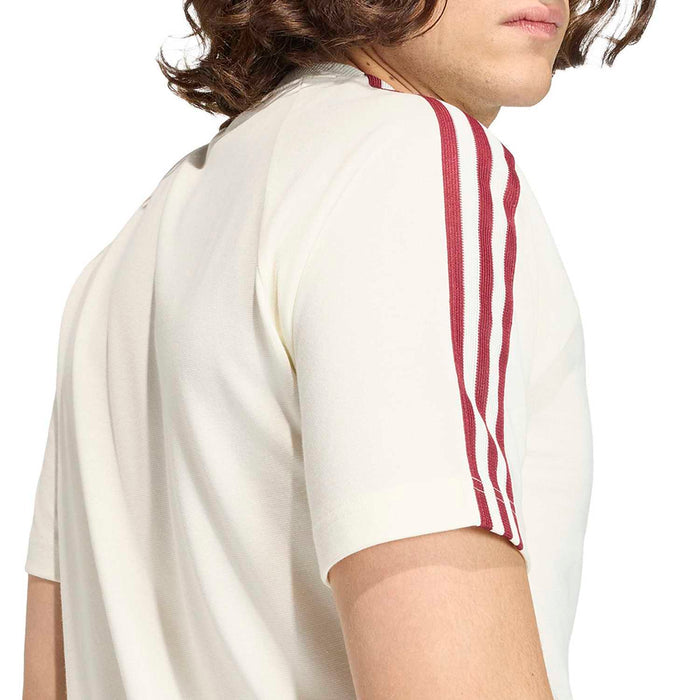 Off-white T-shirt close-up: maroon three-stripe sleeve detail.