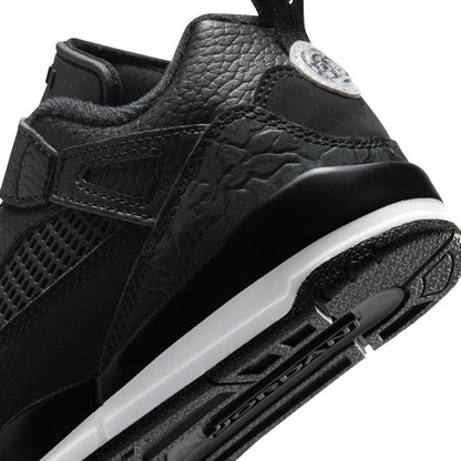 Kids black sneaker close-up with textured side panel, side logo, white midsole