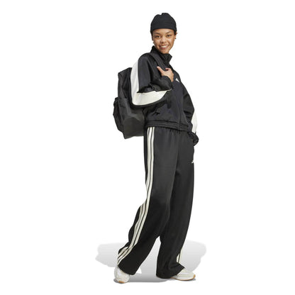 Black womens stadium tracktop with off-white sleeve stripes and high collar.