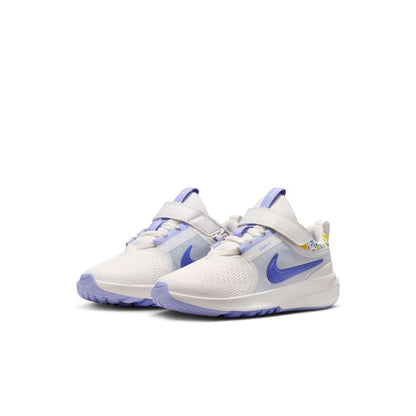 Kids white and blue low-top running shoes, side view with blue swoosh and lace panel
