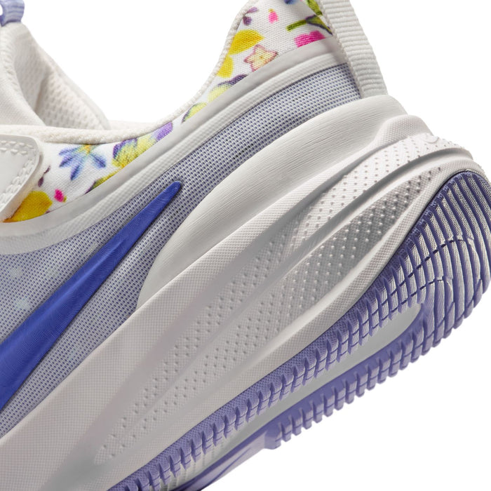 Kids white and blue sneaker midsole and outsole close-up with patterned tread