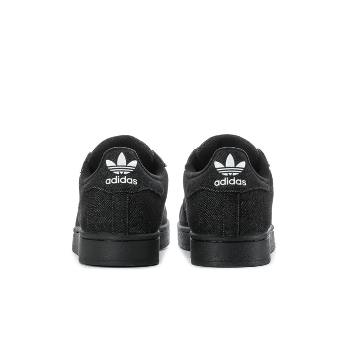 Black low-top sneakers with rear adidas logo and black rubber heel sole