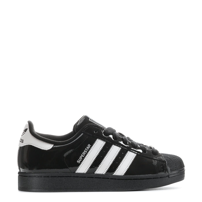 Youth low-top sneakers in black patent with white triple stripes and black laces