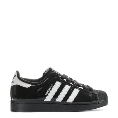 Youth low-top sneakers in black patent with white triple stripes and black laces
