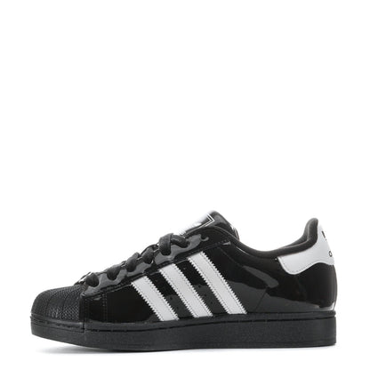 Youth low-top sneakers with white side stripes, black glossy upper, and lace-up