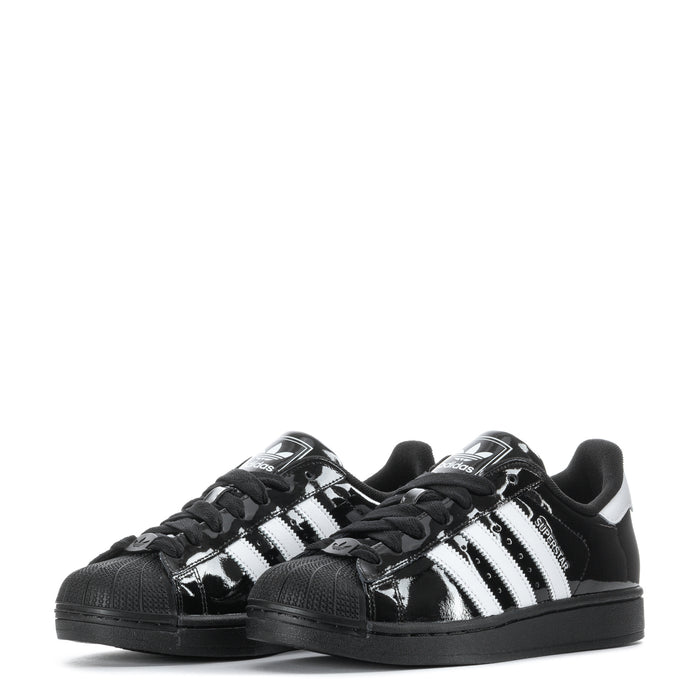 Youth low-top sneakers, black gloss with white stripes and textured toe cap