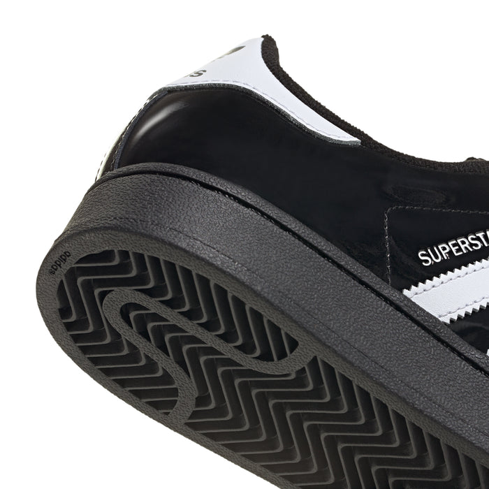 Youth sneakers outsole close-up with rubber tread pattern and heel area