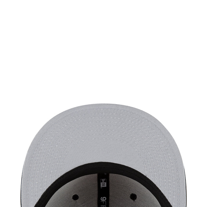 White baseball cap close-up with textured crown and black inner band