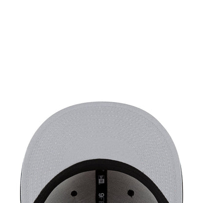 White baseball cap close-up with textured crown and black inner band