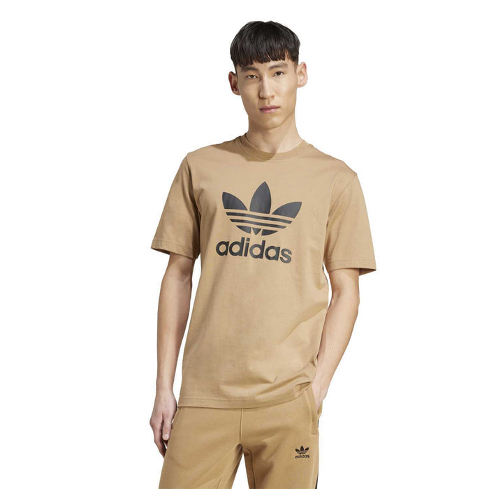 Men's tan adidas logo tee with crew neck and short sleeves, worn by model
